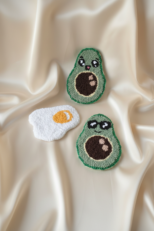 Three avocados with facial expressions on a beige fabric background