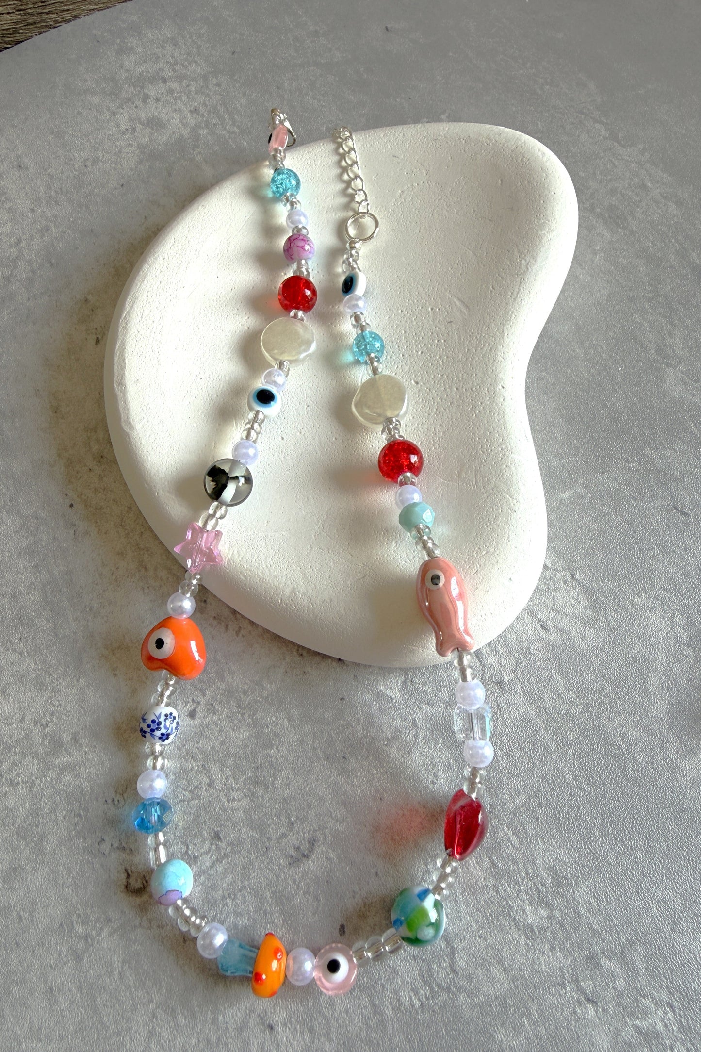 Colorful beaded necklace on a textured surface