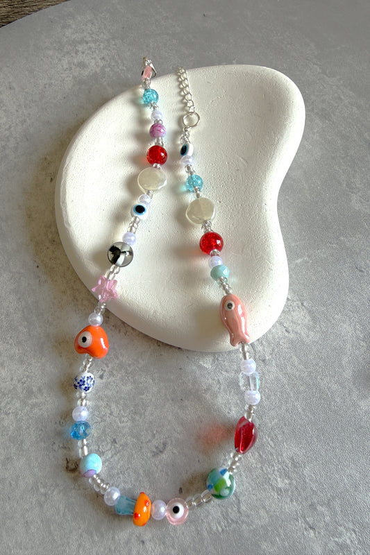 Colorful beaded necklace on a textured surface