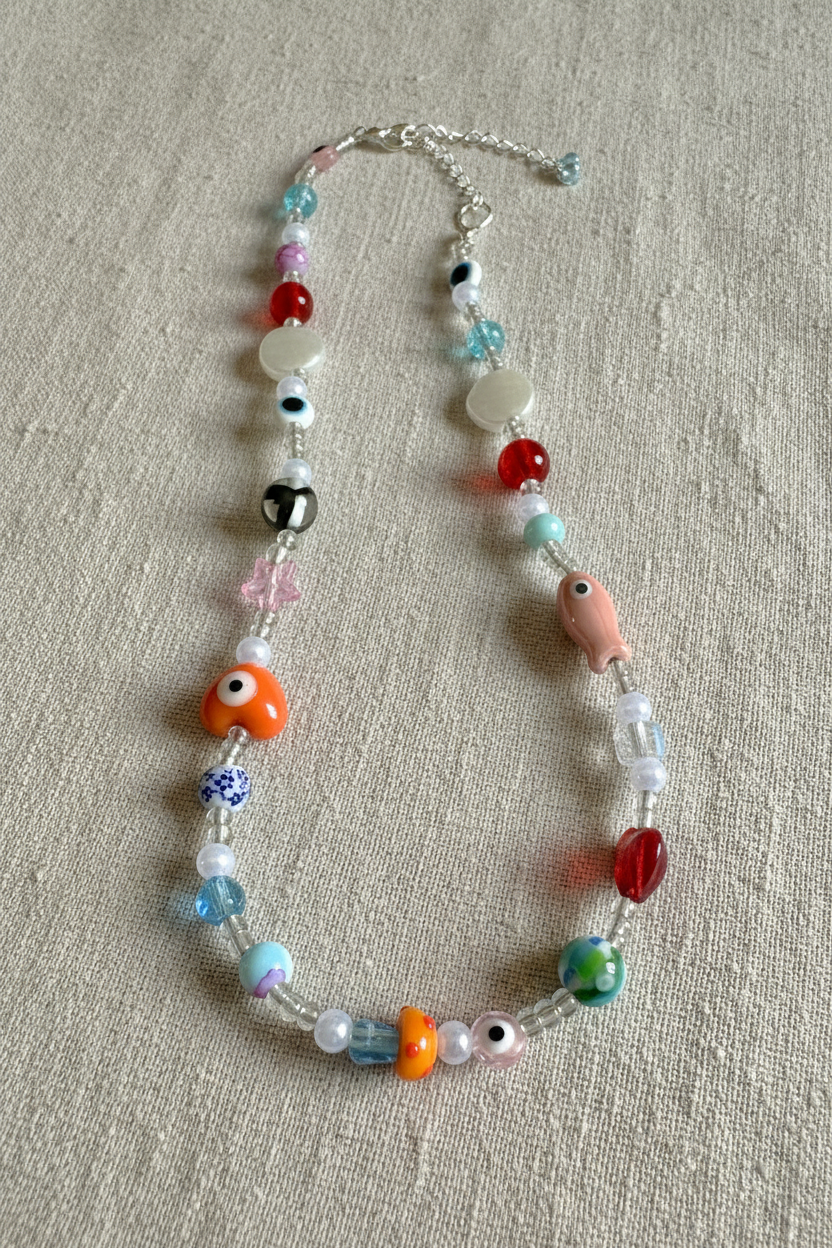 Colorful beaded necklace on a textured surface